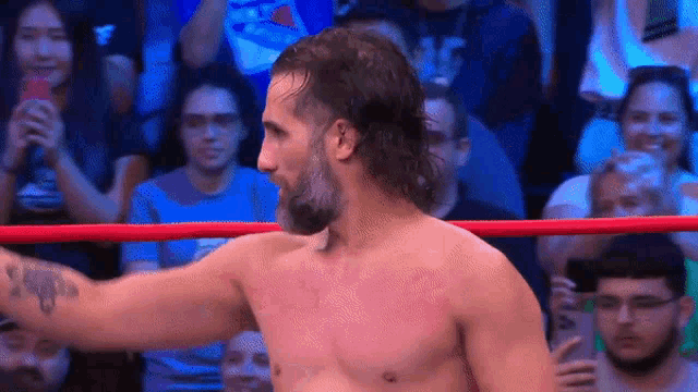 a man with a beard is in a wrestling ring