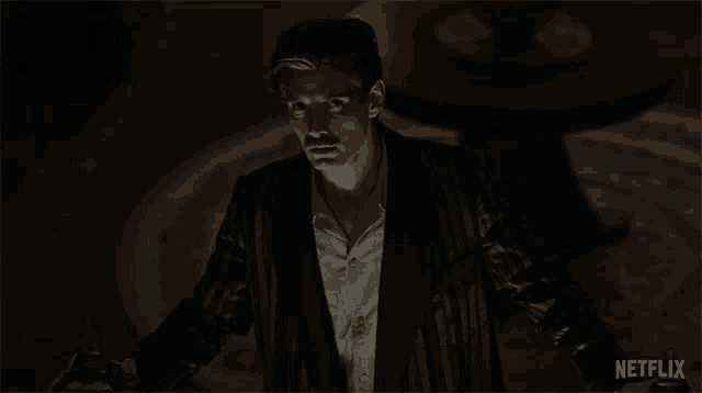 a man standing in a dark room with netflix written on the bottom