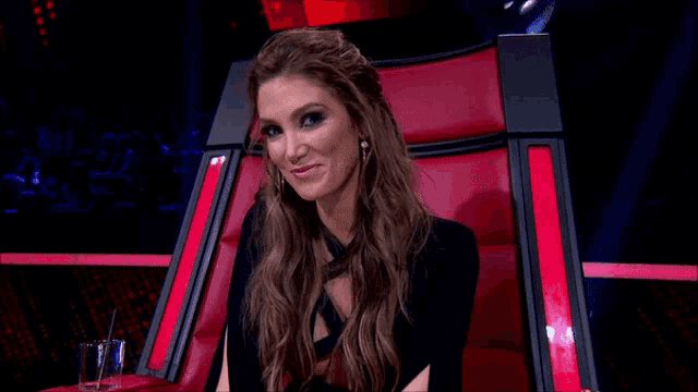 a woman is sitting in a chair with her mouth open