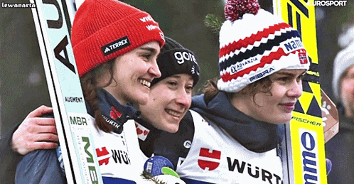 three female skiers are posing for a picture with one wearing a hat that says gore
