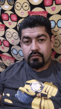 a man with a beard is wearing a t-shirt with a banana on it