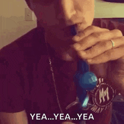 a man is smoking a cigarette with smoke coming out of his mouth and says `` yea ... yea ... yea '' .