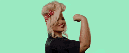 a woman with blonde hair and a red headband is making a funny face with her arms crossed .