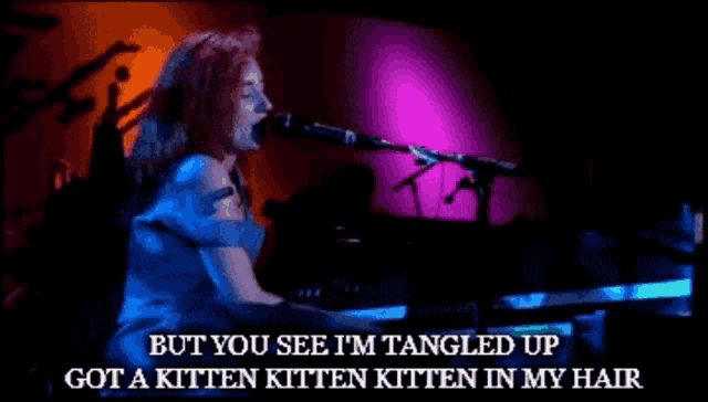 a woman singing into a microphone with the words but you see i 'm tangled up