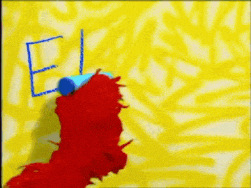 elmo from sesame street is holding a blue object in its mouth .