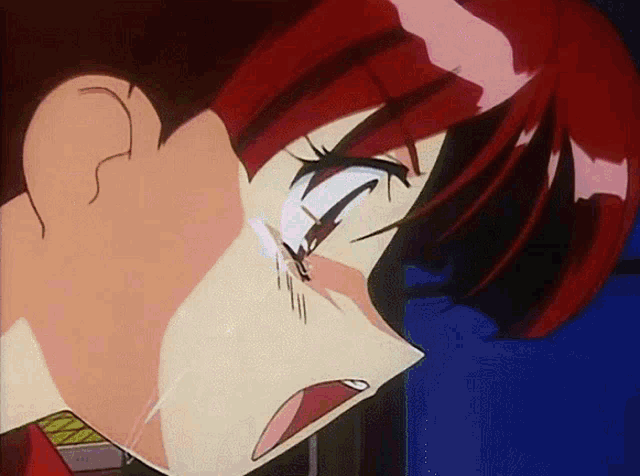 a close up of a person 's face with a tear coming out of their eye