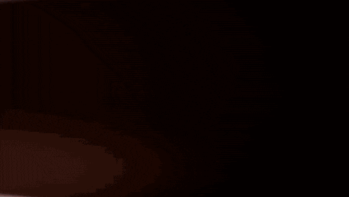 a shadow of a person is cast on a dark surface