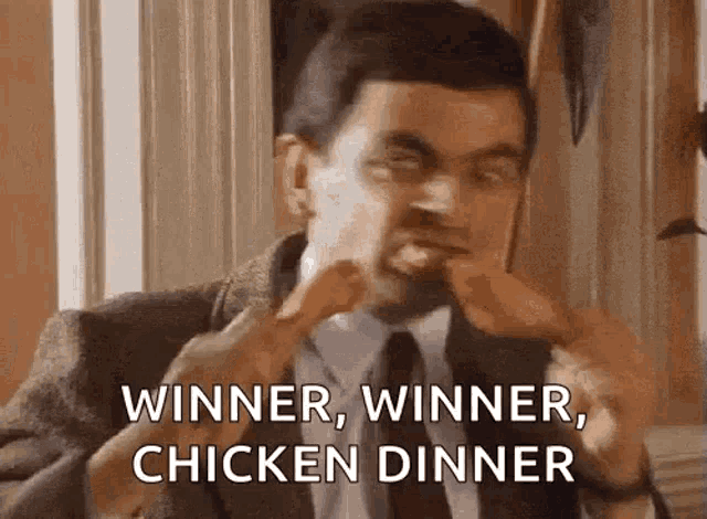 mr bean is eating chicken wings and saying `` winner , winner , chicken dinner ''