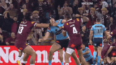 a rugby player with the number 4 on his back is fighting with another player