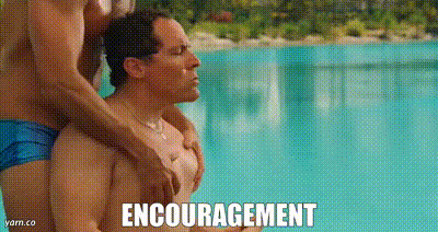 two men are hugging each other in front of a swimming pool and the words `` encouragement '' are written on the screen .