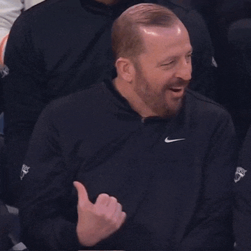 a man with a beard wears a black nike jacket