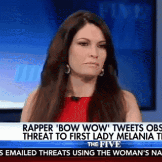 a woman in a red dress is talking on a news channel