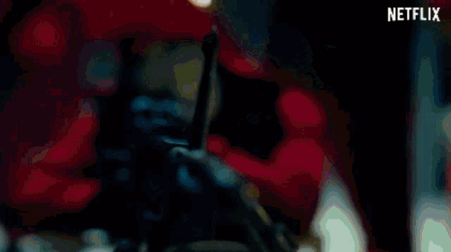 a woman in a dark room with a netflix logo on the bottom