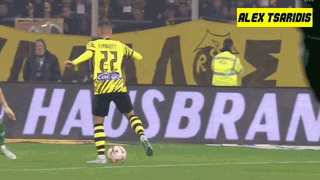 a soccer player with the number 22 on his jersey kicking a ball