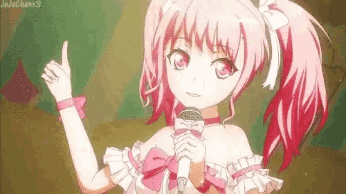 a girl in a pink dress is holding a microphone and giving a thumbs up .