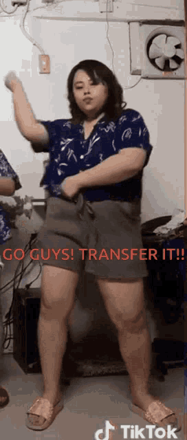a woman is dancing in a room with the words go guys transfer it written in red