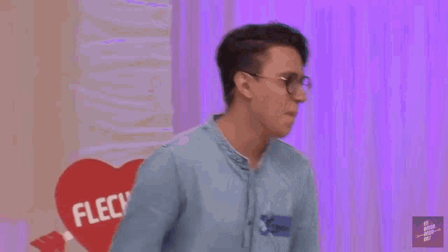 a man with glasses and a name tag that says flecha