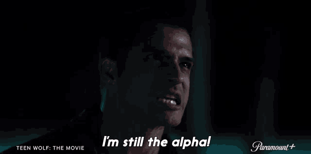 a close up of a man 's face with the words `` i 'm still the alpha '' .
