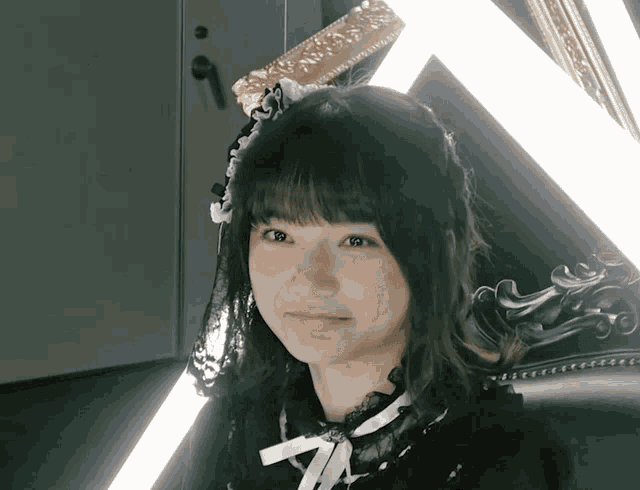 a girl with a veil on her head looks at the camera with a smile on her face