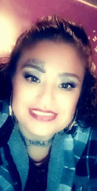 a woman with a tattoo on her forehead that says jdms