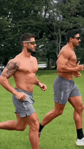 two men running in shorts that say maha on the side