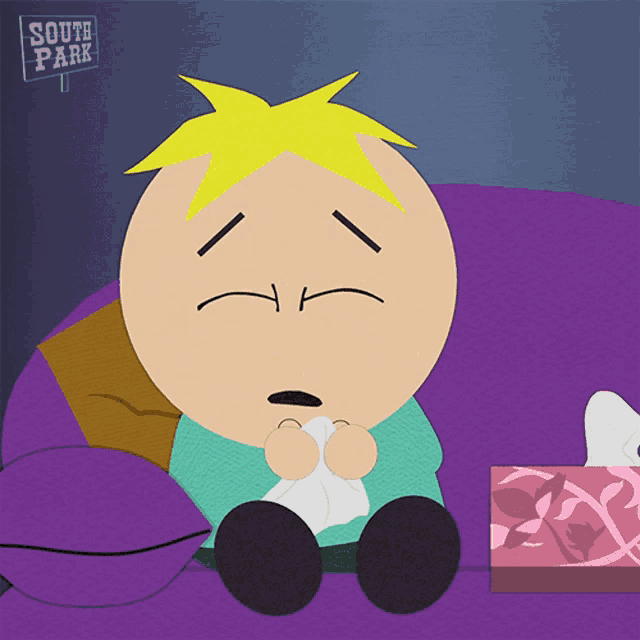 a cartoon character from south park sits on a purple couch