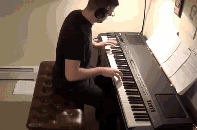 a man is playing a keyboard with a yamaha brand