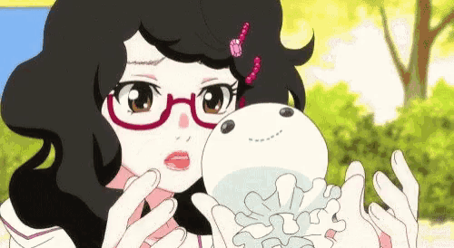 a girl with glasses is holding a stuffed animal .