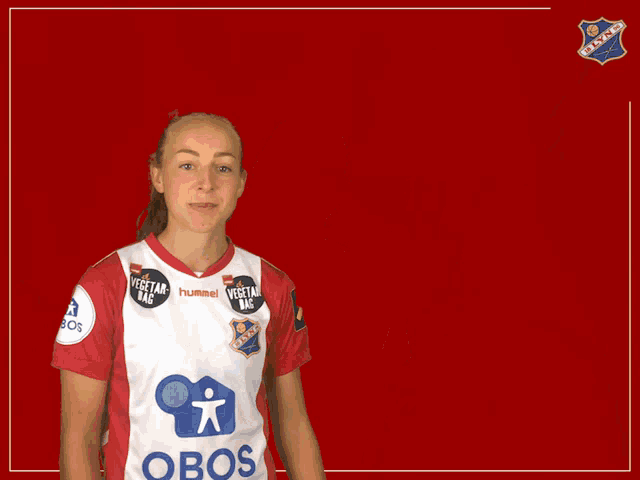 a woman wearing a red and white jersey that says obos on it