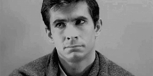 a black and white photo of a man with a serious look on his face .