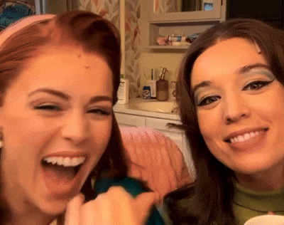 two women are posing for a picture and one of them is wearing a headband