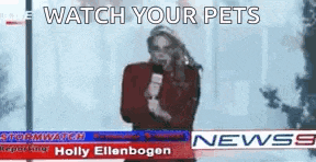 a woman is holding a microphone in front of a news anchor .
