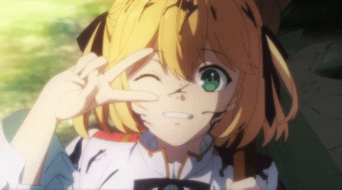 a girl with blonde hair and green eyes giving the peace sign