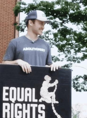 a man holding a sign that says equal rights on it