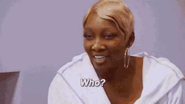 a woman is wearing a white robe and earrings and asking who .
