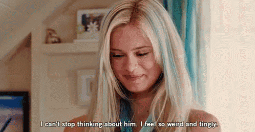 a woman with long blonde hair and blue streaks is talking about a man .