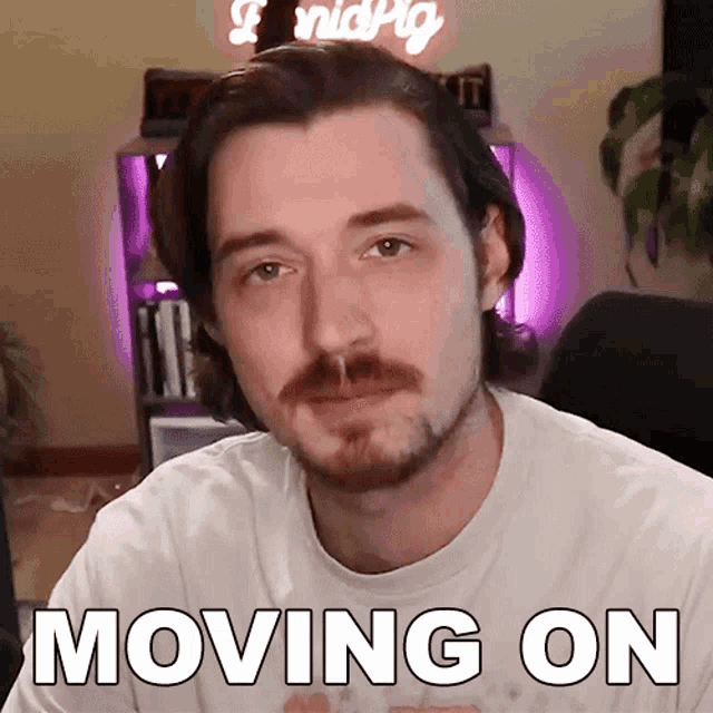 a man with a mustache is wearing a white shirt that says " moving on "