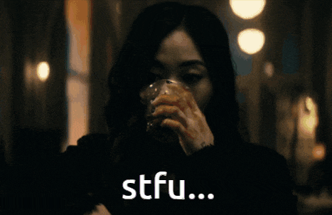 a woman drinking from a glass with the words stfu written on the bottom