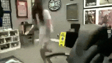 a blurred image of a person standing in a room with a yellow caution sign