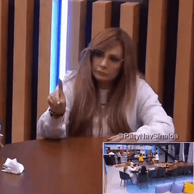 a woman is sitting at a table with a napkin on it .