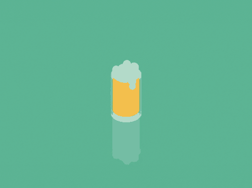 a glass of beer with foam coming out of it on a green surface