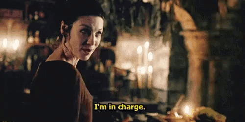 a woman is standing in a dark room and saying i 'm in charge