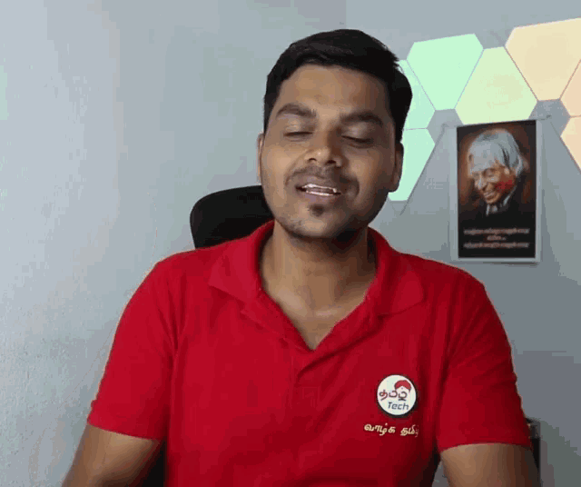 a man wearing a red polo shirt with the word tech on it