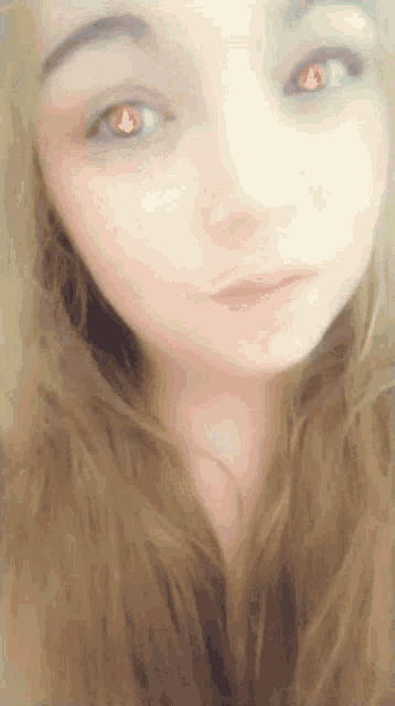 a close up of a woman 's face with her eyes closed