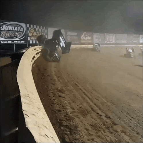 a race track with a juniata beverage sign on the wall