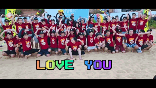 a large group of people are posing for a picture with the words love you in the background
