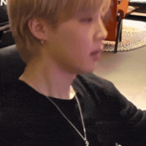 a close up of a person 's face with a necklace around their neck