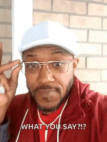 a man wearing glasses and a white hat says what you say
