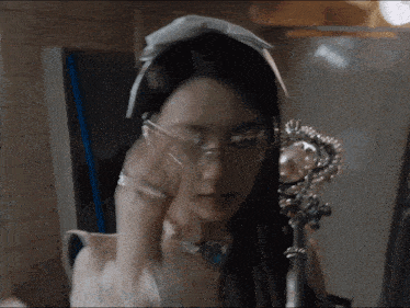 a woman wearing glasses and a white headband
