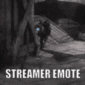 a black and white photo of a person walking down a street with the words `` streamer emote '' .